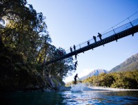 Taya Morrison (10) leaps off a swingbridge on a clear crisp autumn day at Blue Pools near Makarora, Wanaka, New Zealand. 