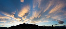 Golden clouds like molten rocks over Lake Hawea, Hawea, New Zealand. 