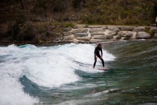 French tourist Jean Soudre surfs the standing wave on the Hawea River near Lake Hawea, New Zealand. 