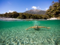 John Watson, of Australia, swims on a clear crisp autumn day at Blue Pools near Makarora, Wanaka, New Zealand. 