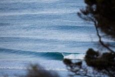 An empty wave peels at a remote beach on Otago Peninsula, Dunedin, New Zealand. 
