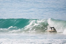 A surfer gets barrelled at a remote beach on Otago Peninsula, Dunedin, New Zealand. 