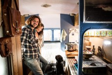 Singer songwriter Joe Wilson with his partner Evie Hall, and dog Ziggy in their house bus parked above Whareakeake, Dunedin, New Zealand. 