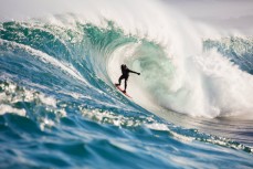 Doug Young takes on a remote reef break on the Otago coast, New Zealand. 