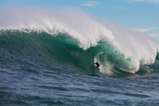 Doug Young draws his line along a warping face at a remote reef break on the Otago coast, New Zealand. 