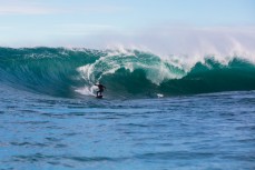 Paul Harrison draws his line along a warping face at a remote reef break on the Otago coast, New Zealand. 