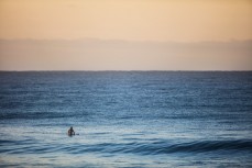 A lone surfer at St Clair Beach, Dunedin, New Zealand. 