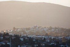 Afternoon sunshine bathes a hill suburb in Dunedin, New Zealand. 