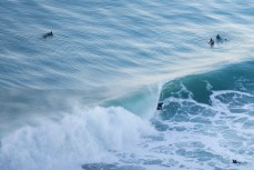 A surfer rides a fun wave at Aramoana on the North Coast, Dunedin, New Zealand. 