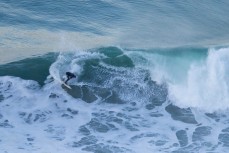 A surfer rides a fun wave at Aramoana on the North Coast, Dunedin, New Zealand. 