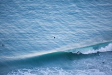 A surfer gets barrelled on a fun day up the North Coast, Dunedin, New Zealand. 