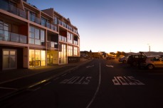 Hotel St Clair illuminated in the morning light at St Clair Beach, Dunedin, New Zealand. 
