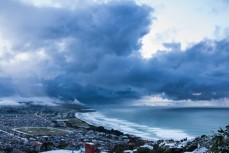 Snow-laden clouds drift through above St Clair, Dunedin, New Zealand. 