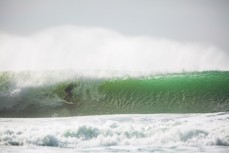 A surfer gets barreled during a solid swell on the north coast, Dunedin, New Zealand. 
