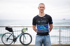 Guinness World Record holder Andrew Nicholson with the bike he rode around the world on in record time at St Clair Beach, Dunedin, New Zealand. 