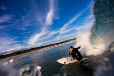 A surfer drives off the bottom at St Kilda Beach, Dunedin, New Zealand. 
