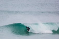 A surfer gets barreled in fun conditions at Blackhead Beach, Dunedin, New Zealand. 