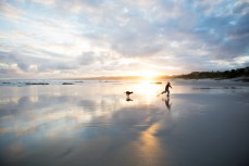 Rewa (9) and Remi play in dusk light at a beach near Birghton, Dunedin, New Zealand. 