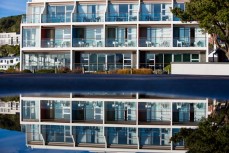 St Clair Hotel reflected in water at St Clair Beach, Dunedin, New Zealand. 