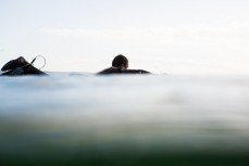 A surfer paddles back out at Blackhead Beach, Dunedin, New Zealand. 