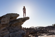 Kristin relaxes in the sunshine at the beach, Mount Maunganui, Bay of Plenty, New Zealand. 