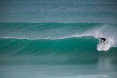 A surfer drops into a promising wall at St Kilda Beach, Dunedin, New Zealand. 