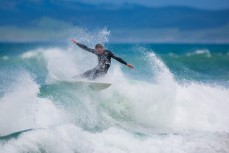 A surfer makes the most of small fun conditions at Blackhead Beach, Dunedin, New Zealand. 