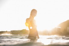 Skinnies ambassador Kristin Crook soaks in the early summer sunshine at Main Beach, Mount Maunganui, Bay of Plenty, New Zealand. 