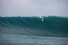 Jimi Crooks paddles into a giant wave in the Catlins, Southland, New Zealand. 