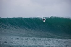 Jimi Crooks paddles into a giant wave in the Catlins, Southland, New Zealand. 