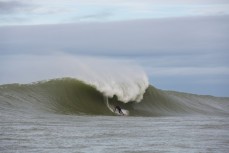 Jamie Gordon rides a giant reefbreal peak in the Catlins, Southland, New Zealand. 