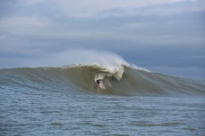 Tom Bracegirdle rides a giant reefbreal peak in the Catlins, Southland, New Zealand. 