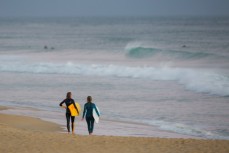Two surfers contemplate a peak during a small swell at St Kilda Beach, Dunedin, New Zealand. 