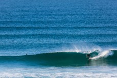 A surfer gets barrelled in calm, clean conditions at Blackhead Beach, Dunedin, New Zealand.