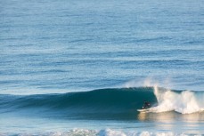 A surfer looks for a barrel in punchy waves at St Kilda, Dunedin, New Zealand.