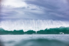 Caught inside in offshore conditions and fun waves at a beachbreak near Raglan, New Zealand.