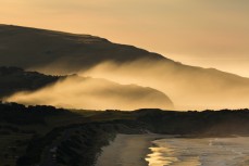 Dawn glow during a new swell at St Kilda, Dunedin, New Zealand.