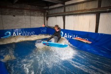 AirWave designer Ross McCarthy and surfer Madoc Barclay test the pre-production version of the wave pool in a warehouse in Dunedin, New Zealand. 
