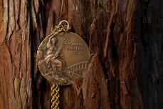 Olympian Rod Dixon wedges his 1972 bronze medal into a redwood tree in Rotorua during some time out to ride mountain bikes in the Central North Island, New Zealand.