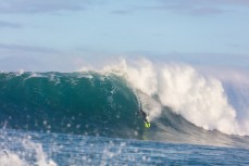 Nat Parsons rides a big wave at a remote reefbreak near Dunedin, New Zealand.