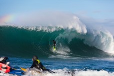 Nat Parsons rides a big wave at a remote reefbreak near Dunedin, New Zealand.