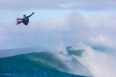 Dale Hunter revels in large surf conditions at a remote reefbreak near Dunedin, New Zealand.
