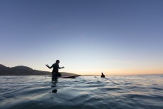 Keara and Tom Brownlie go surfing at dawn near Brighton Beach, Dunedin, New Zealand.