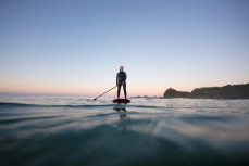 Keara Brownlie surfing at dawn near Brighton Beach, Dunedin, New Zealand.