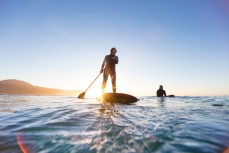 Keara and Tom Brownlie go surfing at dawn near Brighton Beach, Dunedin, New Zealand.