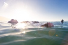 Keara Brownlie floating on the sea near Brighton Beach, Dunedin, New Zealand.