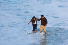 A couple get caught out by a surge at St Kilda, Dunedin, New Zealand.