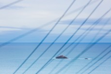 White Island through the powerlines at St Clair, Dunedin, New Zealand.