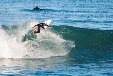 A surfer enjoys clean conditions at Blackhead Beach, Dunedin, New Zealand.