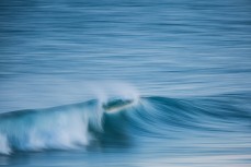 Speed blur in fun, rampy waves at Blackhead Beach, Dunedin, New Zealand.